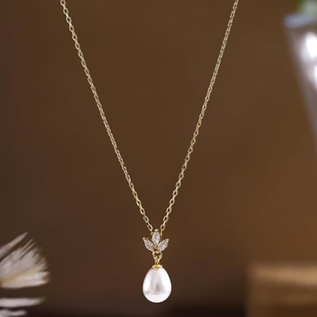 Lieke – Elegante goudkleurige ketting met druppelparel en kristallen bloemdetail